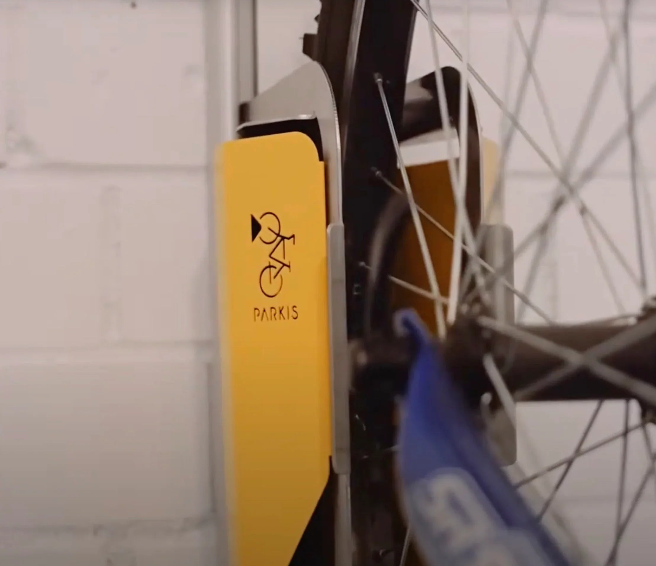 Vertikale Fahrrad-Wandhalterung, gelb, PARKIS MTB, montiert an weißer Wand mit Fahrrad