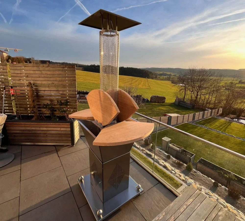 Beheizter Stehtisch mit Pellet-Heizstrahler aus Metall und Holz auf Terrasse, Landschaft im Hintergrund
