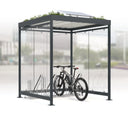 Moderne Fahrradüberdachung aus Glas mit Fahrradständer und Solarpanel auf dem Dach
