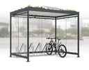 Moderne Fahrradüberdachung aus Metall und Glas mit Fahrradständer, Gründach und Solarpanel