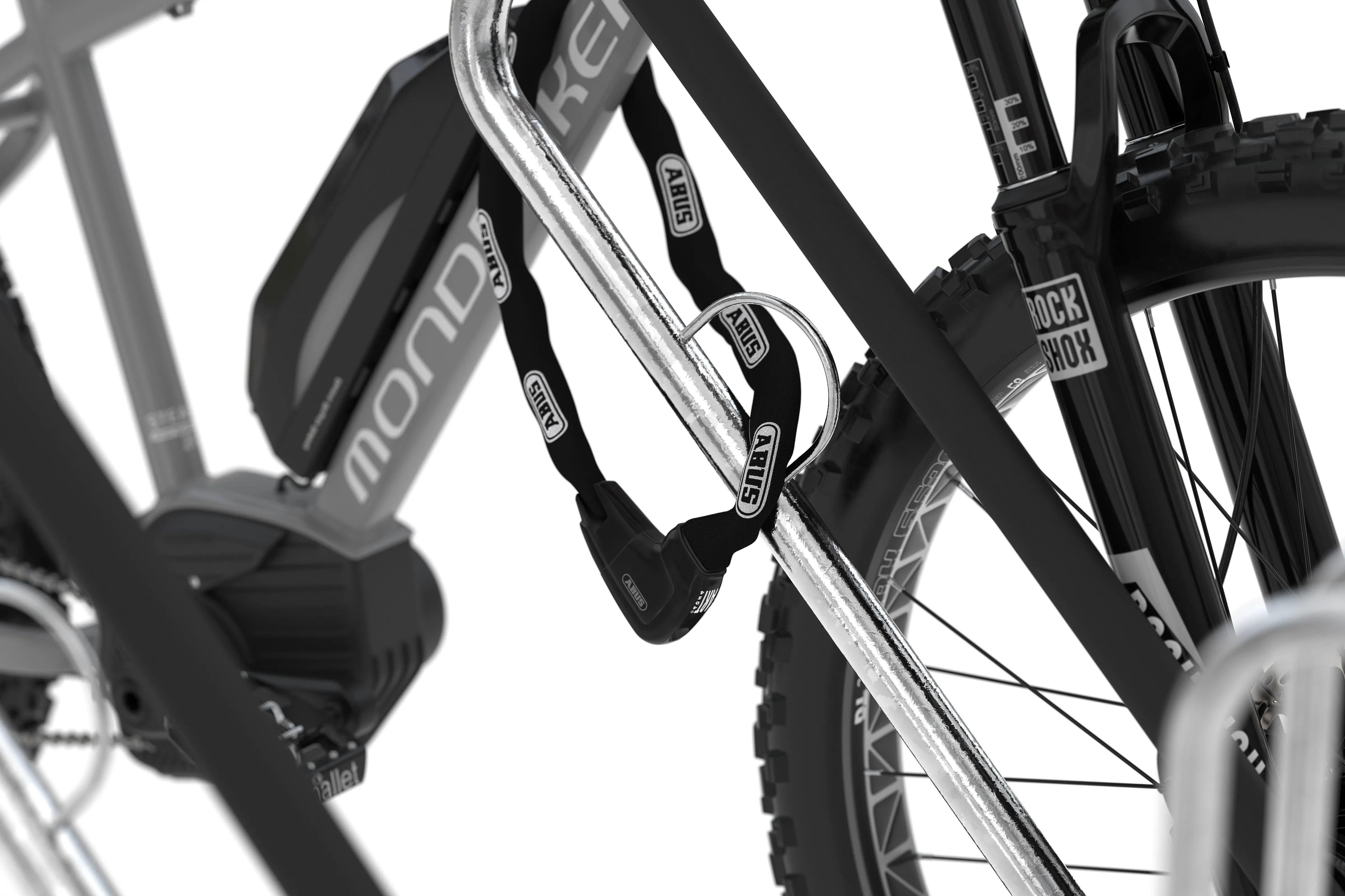 Fahrrad an Fahrradständer aus Metall mit Abus Kettenschloss gesichert, Nahaufnahme