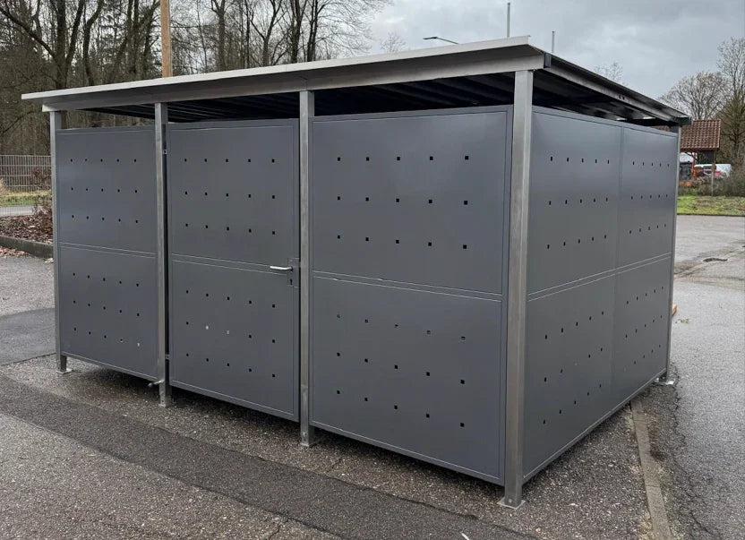 Anthrazitfarbenes Fahrradhaus aus Metall mit flachem Dach, quadratische Belüftungslöcher