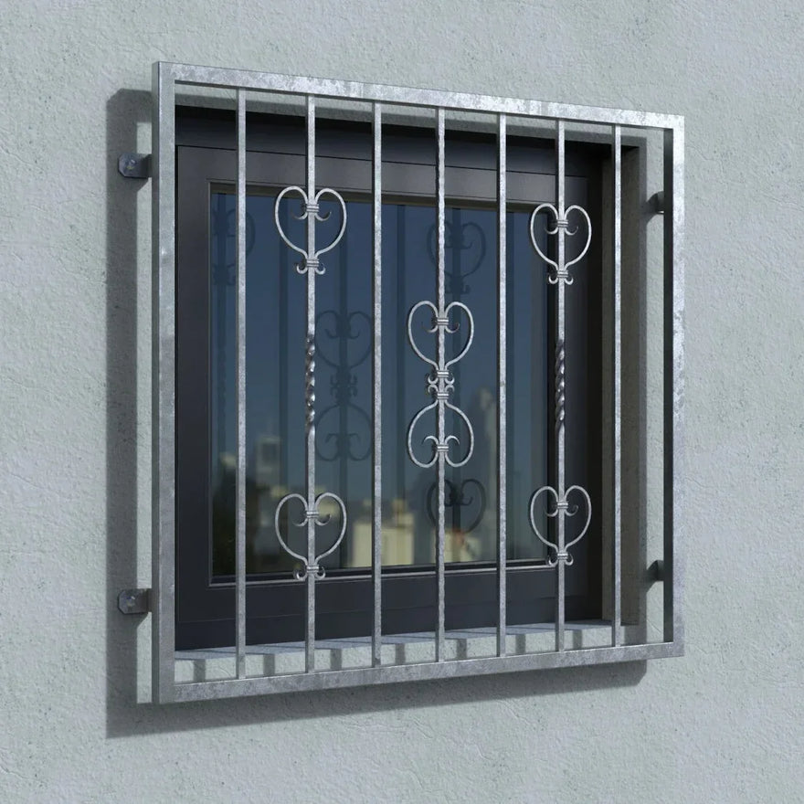 Verzinktes Fenstergitter mit Zierelementen vor modernem Fenster an Außenwand