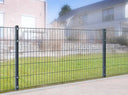 Stabmattenzaun aus Metall als Gartenzaun vor modernem Wohnhaus auf Rasenfläche